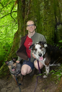 Evan with dogs at a mossy tree